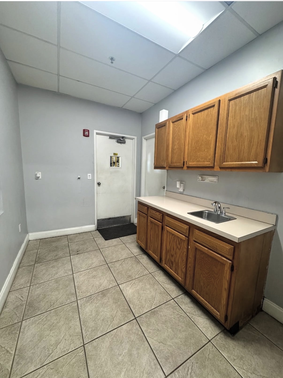 Dated office kitchenette before renovation